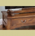 Detail of traditional styled oak TV stand, with drop down fielded panel false drawer, and bespoke oak TV mount.