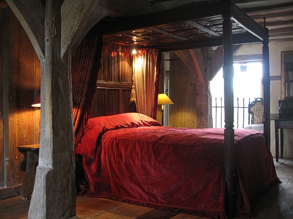 Handmade Tudor style four poster bed in oak framed barn.