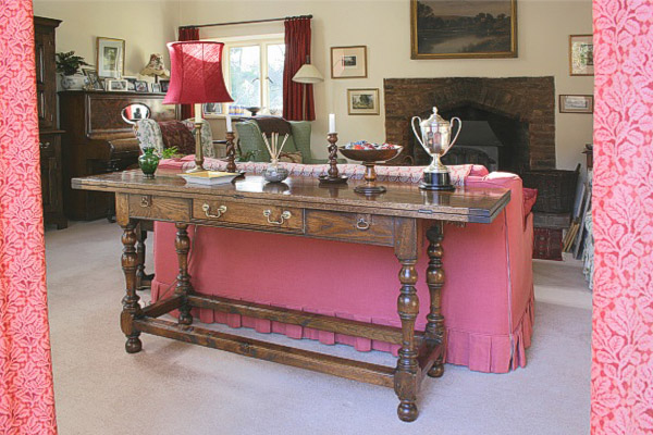 Oak folding table in sitting room of surrey country cottage.