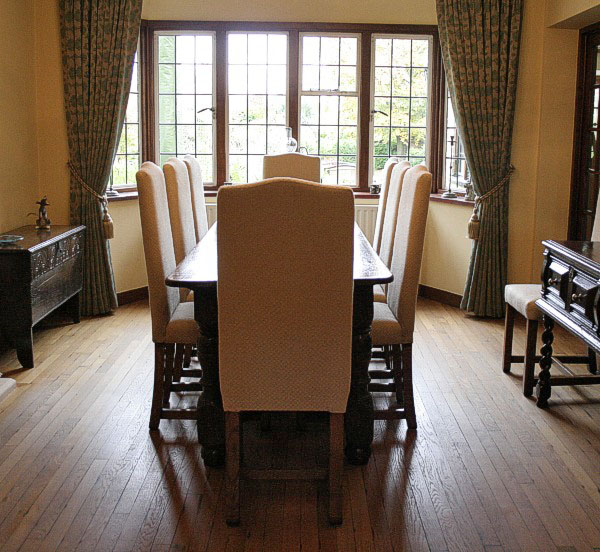 Bespoke narrow fully upholstered side chairs, with antique early oak furniture, in clients Surrey home.