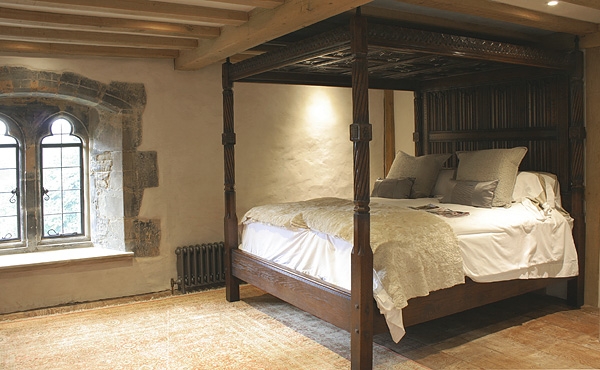 Tudor style carved oak four poster bed in Sussex manor house