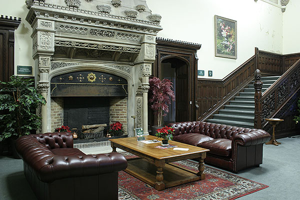 Large oak potboard coffee table and lamp table, in the reception hall of an old priory, converted into prestigious retirement apartments.