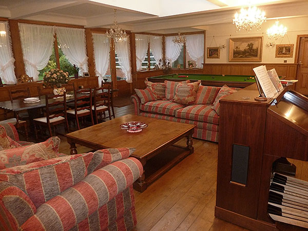 Large square oak coffee table in our clients half-panelled conservatory style sitting/games room.