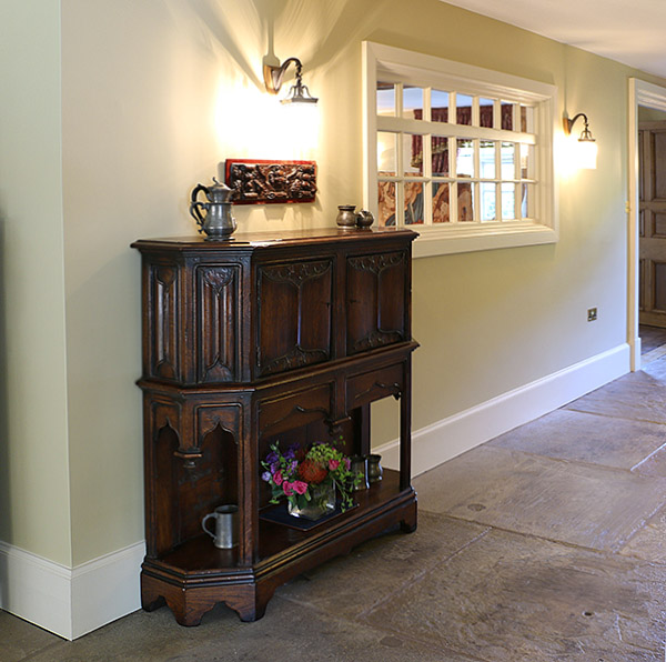 16th century style oak livery cupboard, in the hallway of our clients Warwickshire stone built country house.