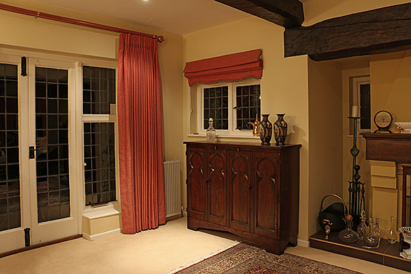 Our clients handmade oak Gothic style TV cabinet, in the sitting room of their Surrey home.