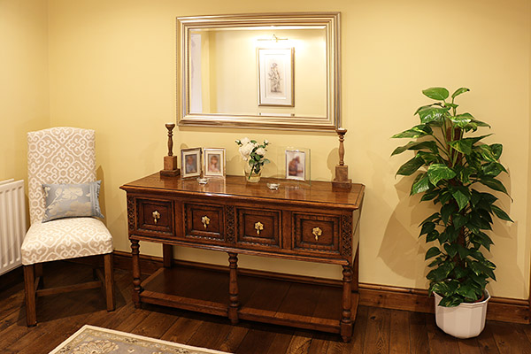 Carved oak pot board dresser base, in the large entrance hallway of our clients West Sussex country home.