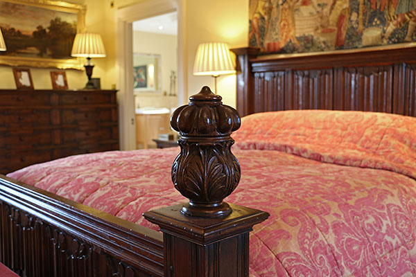 Hand turned and carved oak finial, on linenfold panelled period style bed.