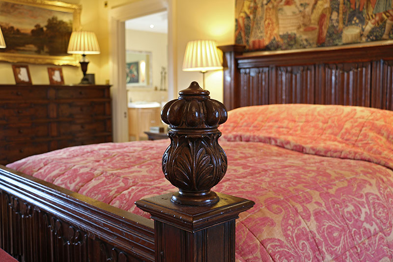 Carved oak detail on our 16th century period style linenfold panelled bed