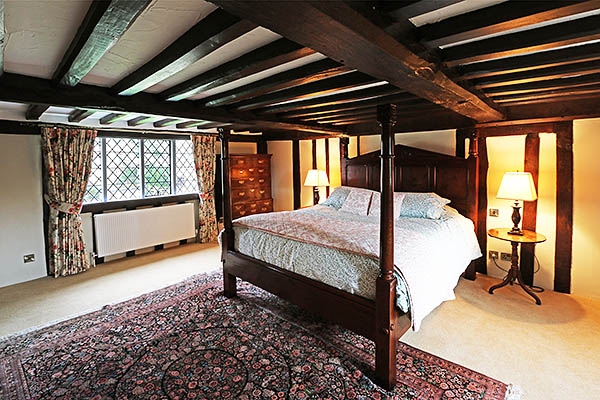 Handmade bespoke designed oak bed in 16th century farmhouse