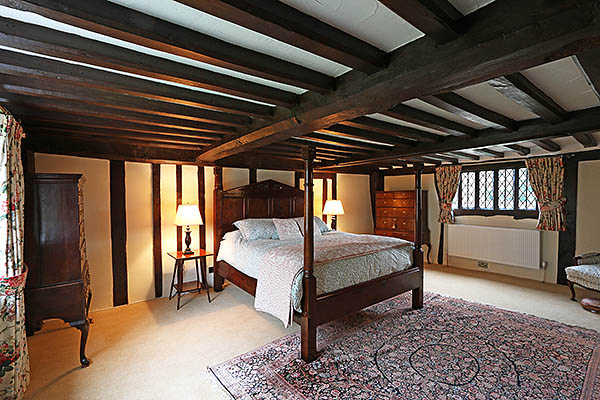 A carefully designed Tudor style oak bed, in the timber framed bedroom our clients circa 1540 Sussex farmhouse.