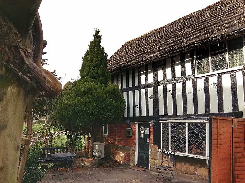 Timber framed building at Cowfold churchyard