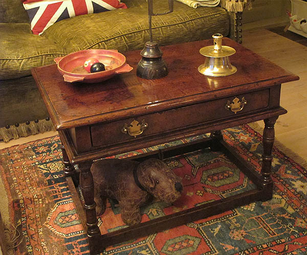 Oak coffee table with drawer, in period interior.