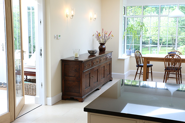 Period style long oak dresser base in kitchen dining room of Sussex home.