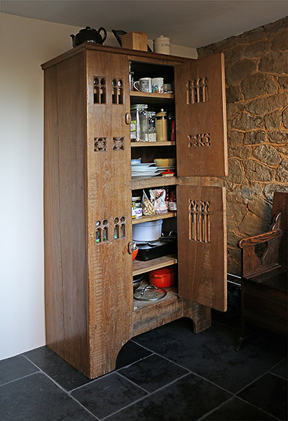 Early 16th century style boarded aumbry, used as kitchen storage cupboard, in Surrey cottage.