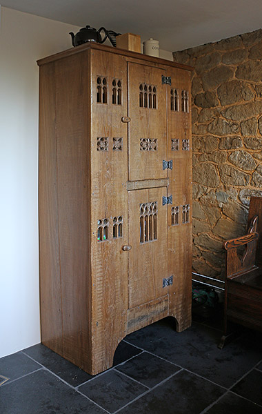 Early 16th century style boarded oak aumbry in the kitchen of our clients Surrey cottage.