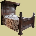 A half tester, or part four-poster, oak bed with hand carved linenfold panels.
