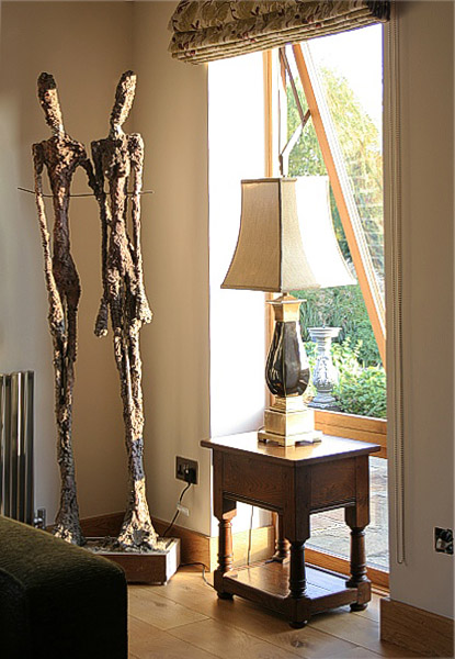 Traditional style oak lamp table, in contemporary interior of country house.