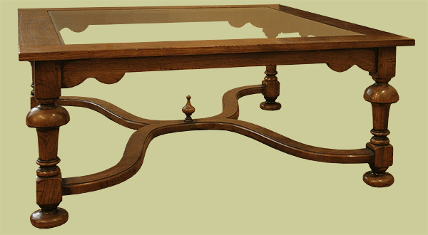 Large square glass top crinoline stretcher oak coffee table.