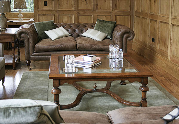 Glass top square, crinoline stretcher, coffee table and lamp table, in oak panelled room.