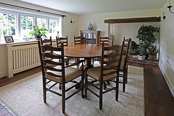 Extended pedestal table & ladderback chairs in farmhouse