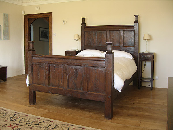 Period style oak bed in West Country manor house.