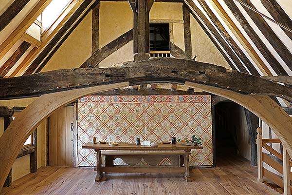 Medieval style oak trestle table and bench in 14th century Wealden hall house.