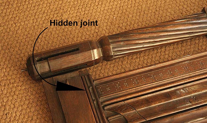 Disguised upper frame joint on hand carved four poster bed headboard assembly