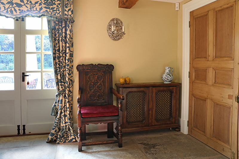 Hand carved Westmoreland style oak armchair and bespoke made radiator cover, in Warwickshire country home