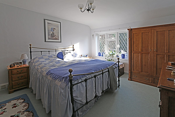 Oak bedside cabinets and wardrobe in the bedroom of our clients Surrey country house.