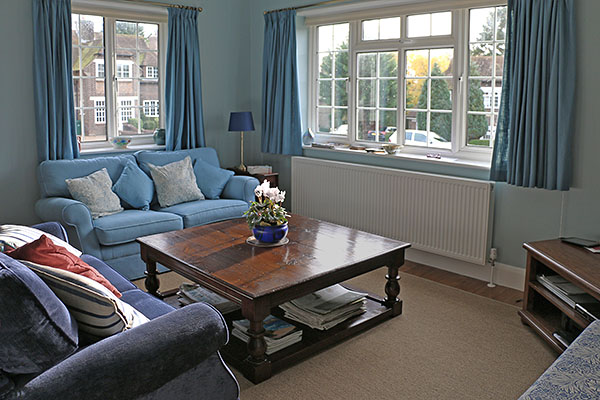 Large square oak potboard coffee table in sitting room of Sussex home.