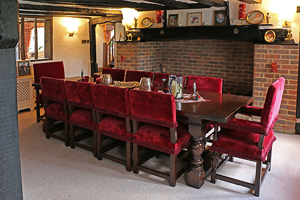 Antique style oak table and upholstered chairs in mid 17th century Surrey home.