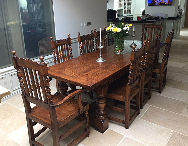 Period style oak refectory table and carved dining chairs in Cambridge kitchen