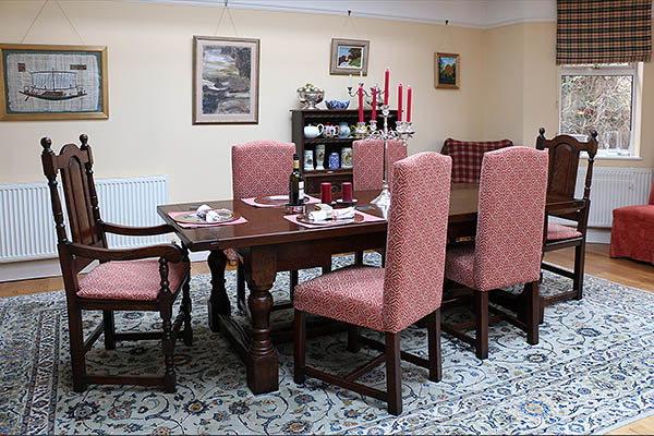 Fully upholstered and solid seat period style oak dining chairs in Sussex home