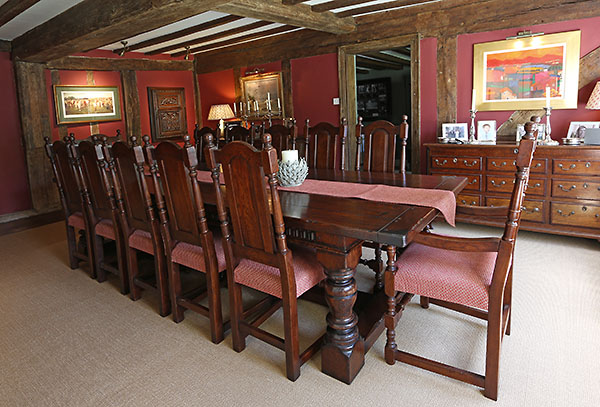 Period style oak table and chairs in 16th century timber framed interior