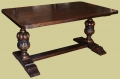 Oak pedestal dining table with Elizabethan style hand carved columns.