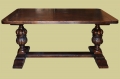 Oak pedestal dining table with Elizabethan style hand carved columns, side view