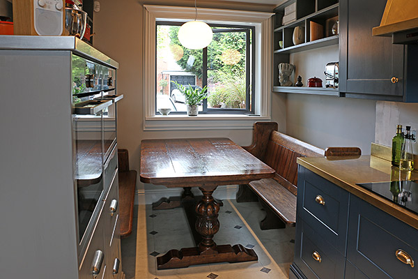 An Elizabethan style carved oak table in a contemporary kitchen