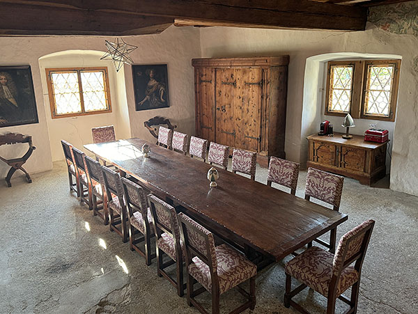 Large oak dining table and chairs in Italian castle