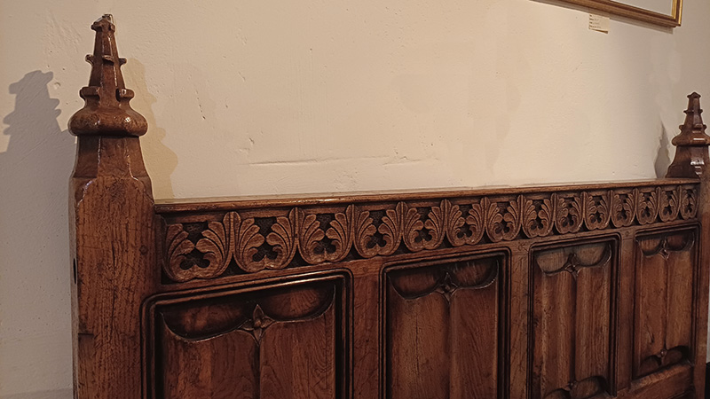Medieval style carved oak bed headboard detail