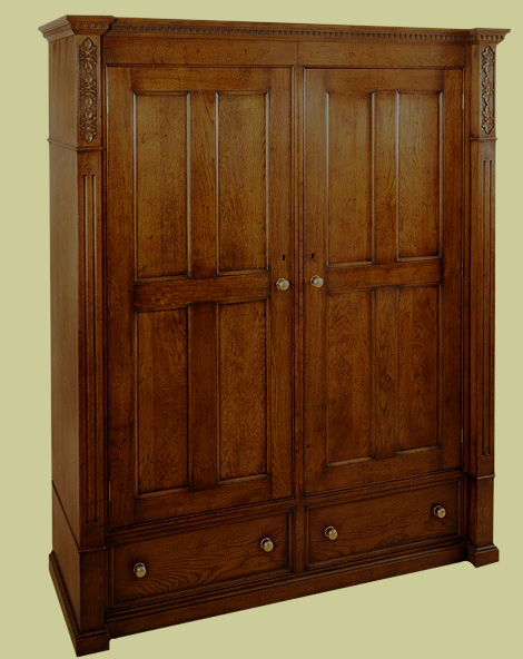 Bespoke oak four-panelled wardrobe, with two drawers and decorative features.