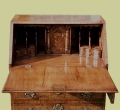 Detail of walnut veneered traditionally styled 5-drawer bureau.